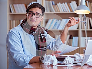 Young book writer writing in library