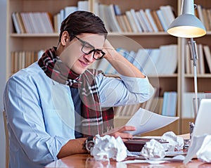 Young book writer writing in library