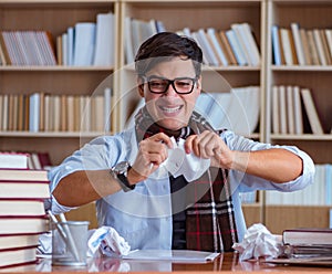 Young book writer writing in library