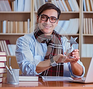 Young book writer writing in library