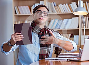 Young book writer writing in library