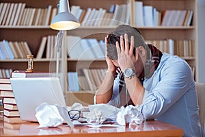 The young book writer writing in library photo