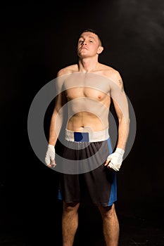 Young boxer breathing deeply before a fight