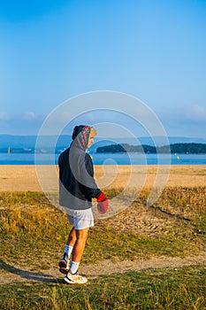 young boxer getting ready to his training with a sea view