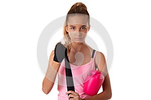 Young boxer girl puts protective bandages on her hands for box training with boxing gloves in the ring. Fighter girl preparing for