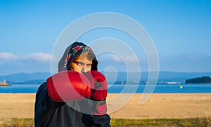 young boxer posing throwing a punch
