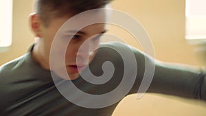 Young boxer practicing with a punching bag