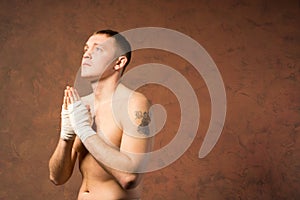 Young boxer praying before a match