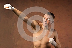 Young boxer throwing an upwards punch