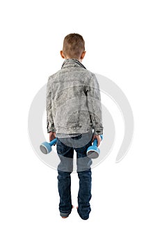 Young boy 6-9 years old with dumbbells isolated on white background. Back view. Physical education concept for a child