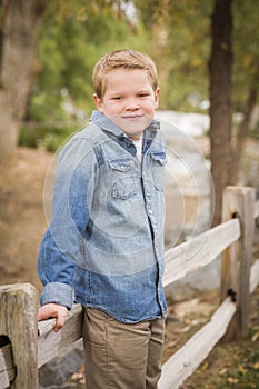 Young Boy Against Fence in Park