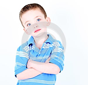 Young boy with arms crossed isolated