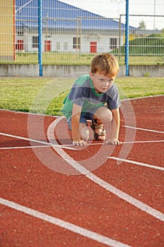 Young boy on athletic stadium