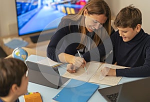 Young boy attends an online classes with parental support