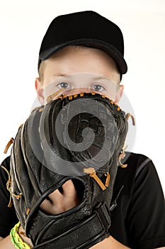 Young boy baseball pitcher peering over glove ready to pitch