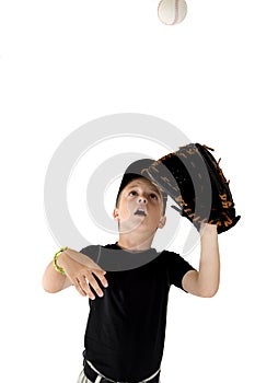 Young boy baseball player focused on catching the baseball