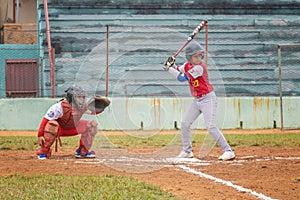 a child getting ready to bat at a baseball game with catcher and umpire