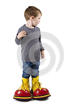 Young boy with big clown shoes