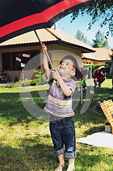 Young boy with big umbrella