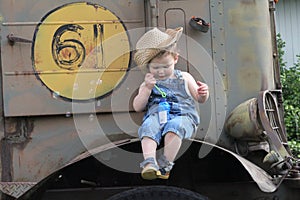 Young boy blowing bubbles on vintage tractor