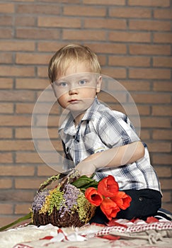 Young boy with a bouquet of flowers