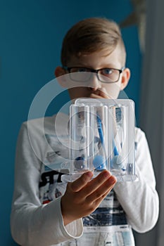 Young boy breaths deep exercise with incentive spirometer