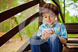 Young boy browsing mobile internet on phone