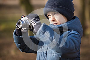Young boy with camera taking picture