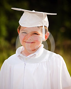 Young boy with cap and gown