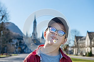 Young boy with the cathedral-sanctuary of Lourdes France