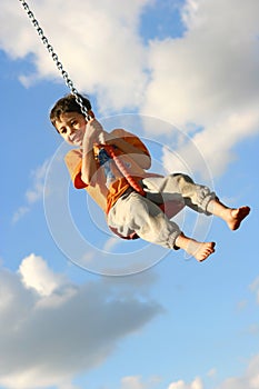 Young boy on chain swing