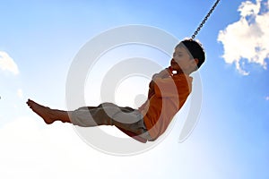 Young boy on chain swing