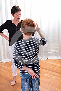 Young boy is cheating - mother looking angry