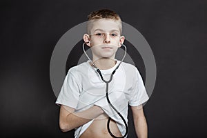 Young Boy Checking his Heart Beat with Stethoscope