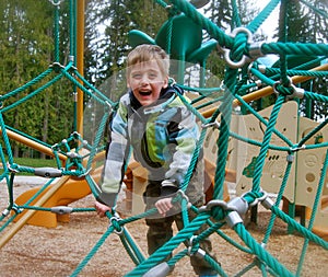 Young Boy Climbing Playground Structure
