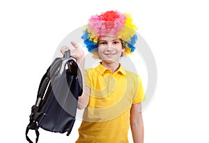 The young boy in clown wig with school satchel