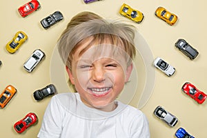 Young boy with colorful small car toys