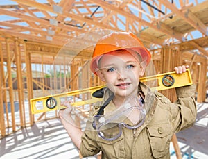 Young Boy Contractor With Level On Site Inside New Home Construction Framing.