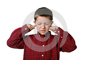 Young boy covering his ears, studio shot