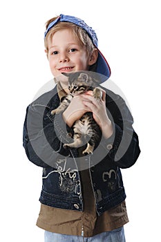 Young boy cuddling pet cat