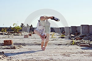 Young boy dancing break dance on the street