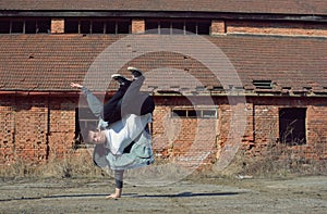 Young boy dancing breakdance on the street