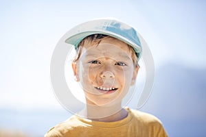 Young boy with with dirty smudges on face after playing outdoors