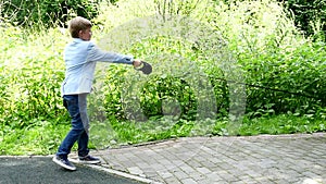 Young boy with dog in green park background slow motion.