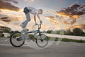 Young boy doing dangerous tricks on bike