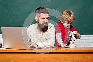 Young boy doing his school homework with his father. Back to school. Education and learning people concept - little