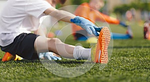 Young Boy Doing Soccer Stretching Exercises. Kids in Football Goalkeepers Training