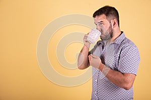 Young boy doing  taking coffe blue background