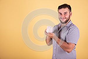 Young boy doing taking coffe yellow background