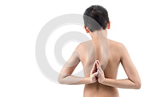 Young boy doing yoga exercise in Virasana